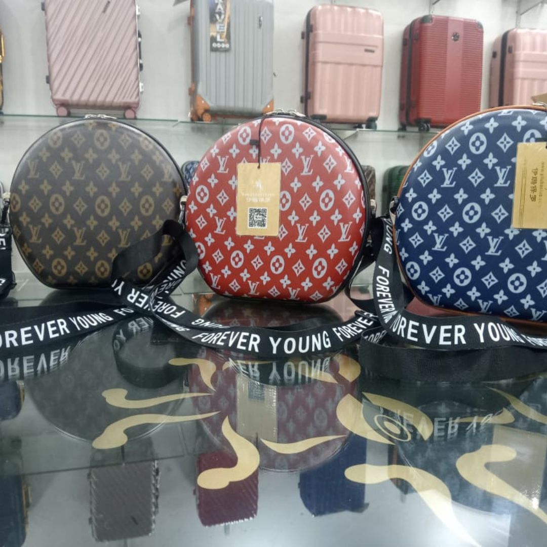 Round shape branded crossbody bag for girls